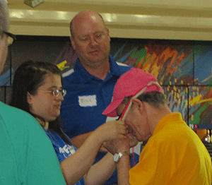 Adela Brinceanu and Bill Berry assist an athlete.c