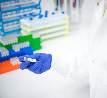 ZeptoMetrix lab worker holds a vial with Delta Variant Panel Quality Control
