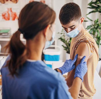 Nurse placing bandage of a child after a vaccines